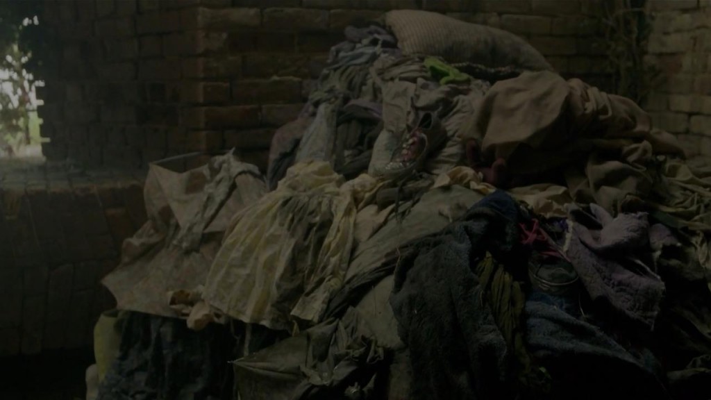 piles of clothes left over from earlier victims (zoom in for extra pathos!)